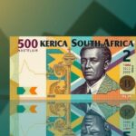 Depiction of South African rand currency on a reflective surface with financial graphs in the background.