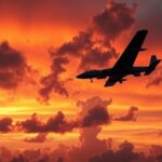 A military aircraft in a dramatic sunset sky, symbolizing airstrikes with dynamic clouds in a warm color palette.