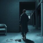 A dark, confined space representing the theme of detention, with muted colors symbolizing despair and uncertainty.